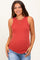 woman wearing a rust ribbed maternity tank top with a curved hem and layered necklaces
