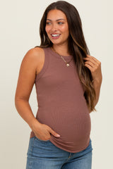 woman wearing a brown ribbed maternity tank top and showing her baby bump while smiling