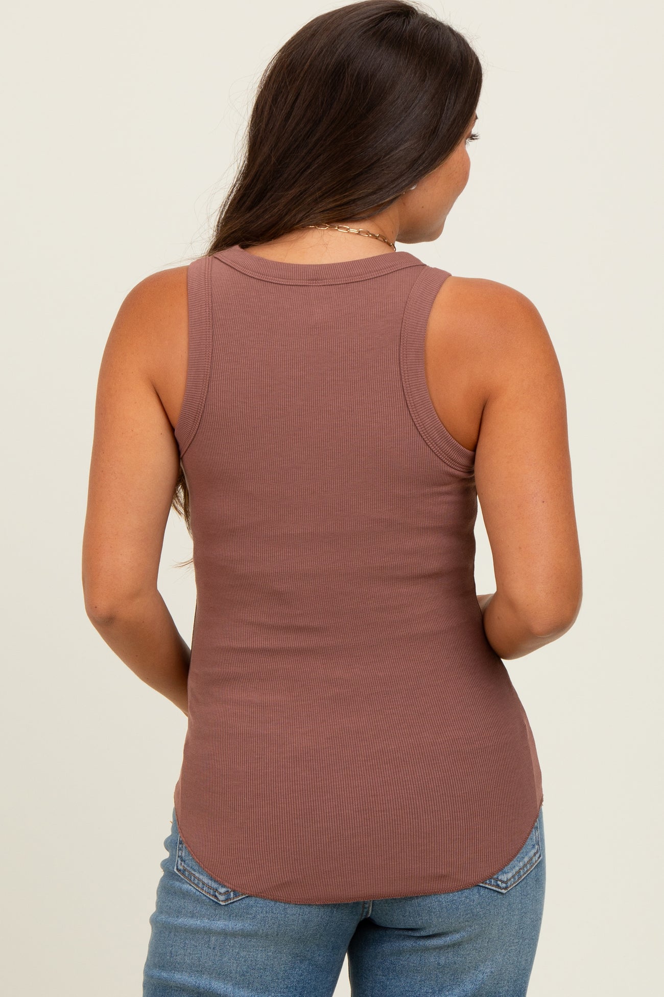 woman wearing a mauve ribbed maternity tank top, showing the back and a relaxed fit