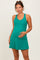 woman wearing a green maternity dress with a scoop neckline and flared skirt, showcasing her baby bump