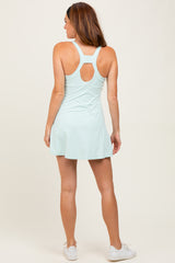 woman wearing a light blue athletic dress with a racerback design and a flared skirt
