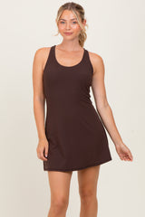 woman wearing a dark brown sleeveless mini dress with a fitted silhouette