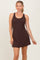 woman wearing a dark brown sleeveless mini dress with a fitted silhouette