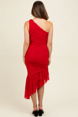 woman wearing a red one-shoulder ruched maternity dress with a ruffled hem and a fitted silhouette