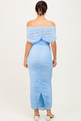 woman wearing a light blue off-the-shoulder ruched maxi dress with a back slit and flowing sleeves