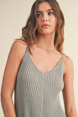 woman wearing a gray ribbed tank top with thin straps and a V-neckline, styled with a delicate necklace