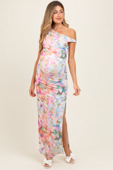 woman wearing a colorful floral off-the-shoulder maternity dress with a side slit and a visible baby bump