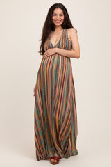 woman wearing a colorful striped maternity maxi dress with a deep v-neck and holding her baby bump