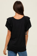 woman wearing a black short sleeve top with ruffle detail and a relaxed fit, viewed from the back
