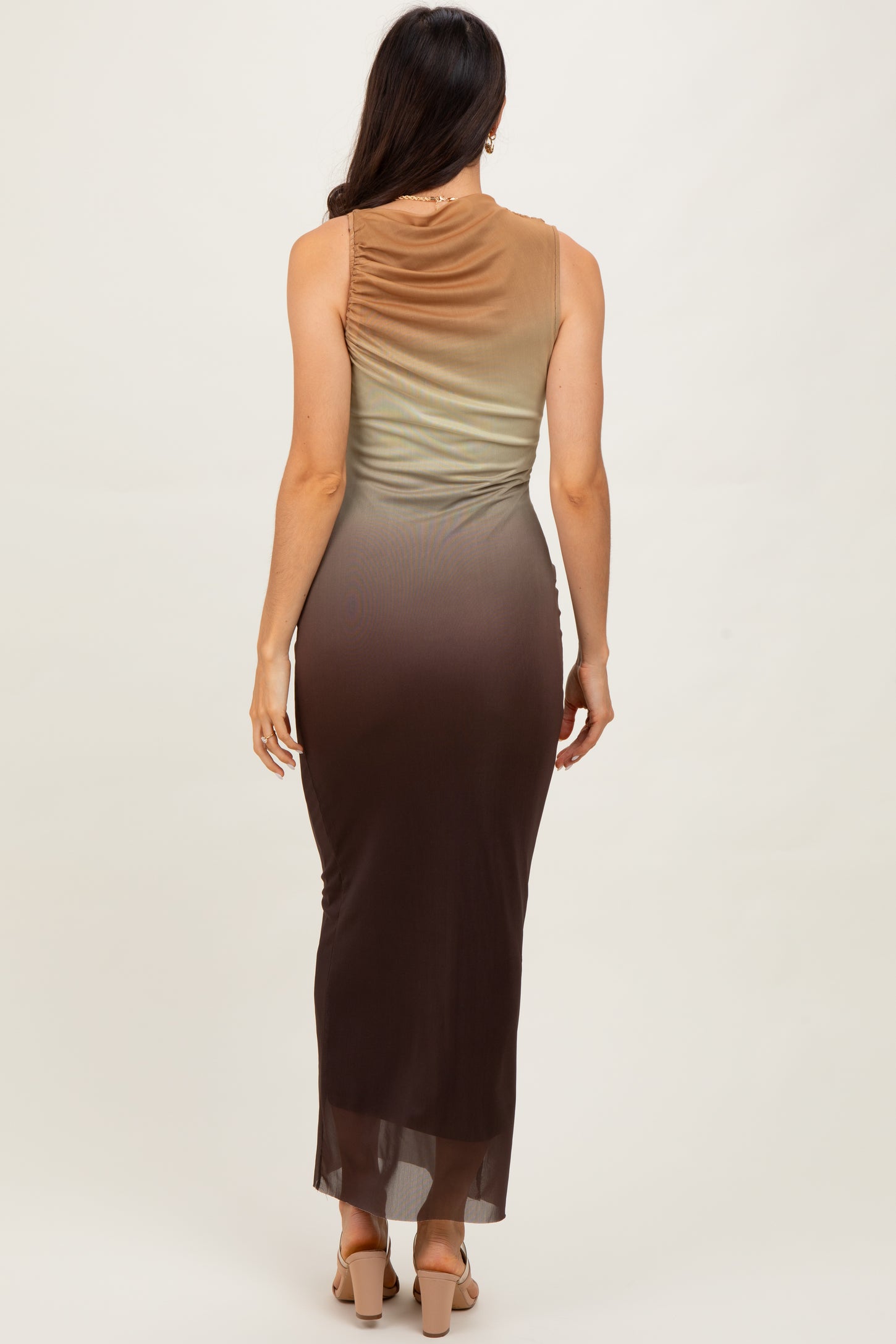 woman wearing a sleeveless ombre maxi dress transitioning from green to brown, showing a fitted silhouette from the back