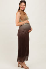 woman wearing a color-blocked maternity dress with a fitted bodice and flowing skirt, showcasing her baby bump