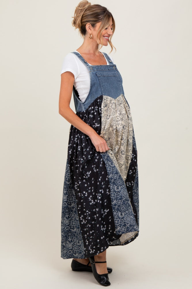 woman wearing a denim maternity maxi dress with a mix of floral patterns and a visible baby bump