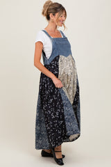 woman wearing a denim maternity maxi dress with a mix of floral patterns and a visible baby bump