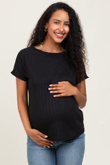 woman wearing a black short sleeve maternity top and holding her baby bump