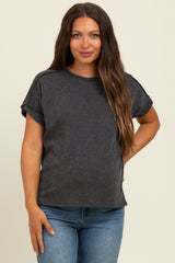 woman wearing a dark gray striped maternity top with rolled sleeves and a visible baby bump