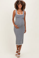 woman wearing a black and white checkered maternity dress with a fitted silhouette and her baby bump visible
