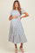 woman wearing a striped maternity maxi dress with short sleeves and a tiered skirt, holding her baby bump