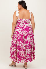woman wearing a pink and white floral plus size maxi dress with adjustable tie straps, shown from the back