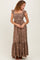 woman wearing a brown floral maxi dress with ruffled straps and tiered skirt