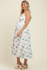 woman wearing a floral print maternity dress and showing off her baby bump