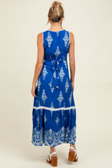 woman wearing a blue patterned maternity maxi dress with a tie waist and ankle-length skirt