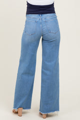 maternity wear light wash wide leg jeans with frayed hem, view of the back, model wearing them with a navy top
