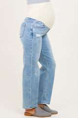 woman wearing light blue maternity jeans with a distressed finish and a supportive belly band, showing her baby bump