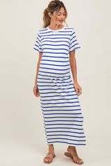 woman wearing a white maternity dress with blue stripes and a visible baby bump