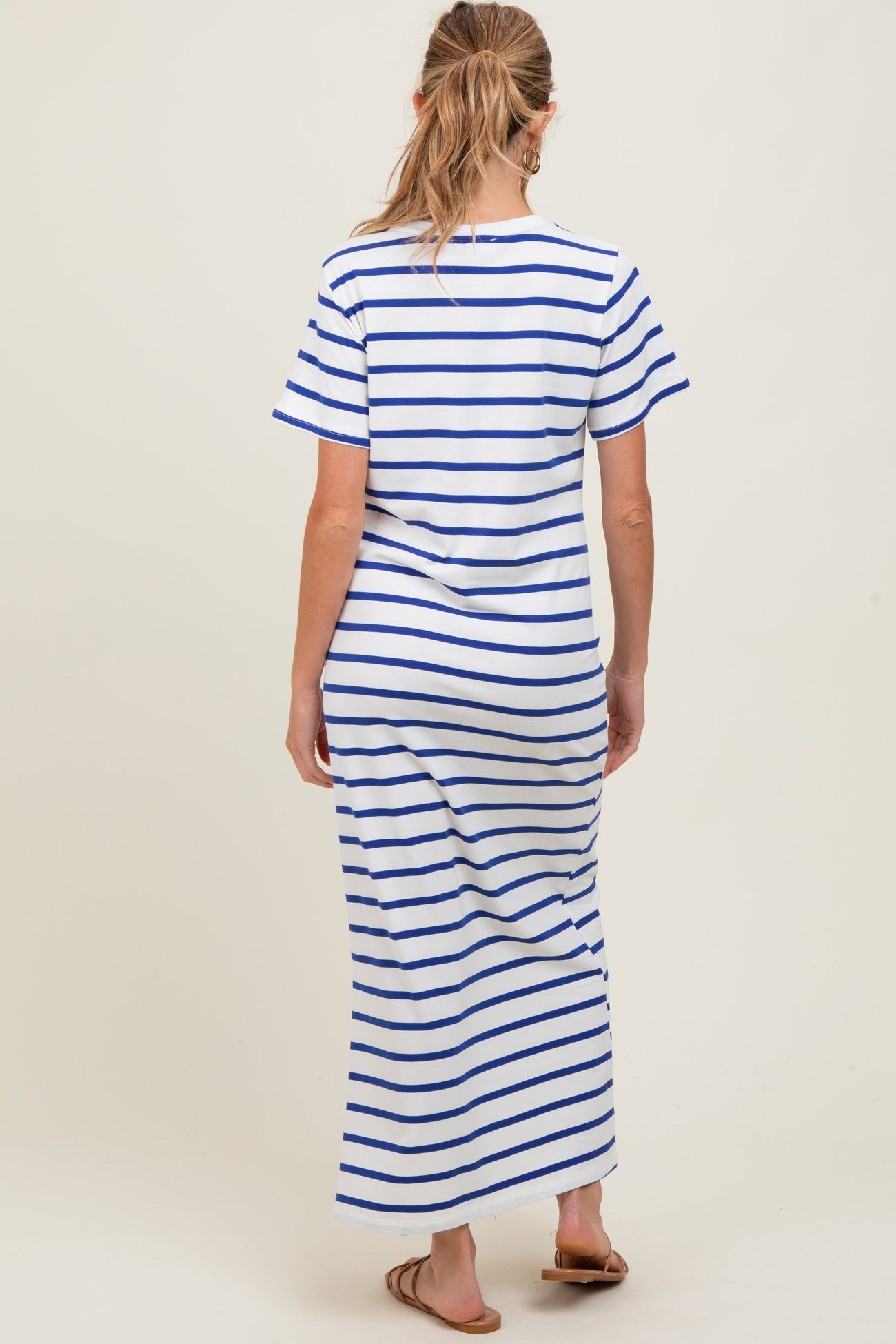 woman wearing a white and blue striped maternity maxi dress with short sleeves and a relaxed fit