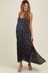 woman wearing a navy blue maternity maxi dress with a paisley print and a visible baby bump