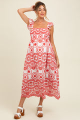 woman wearing a red and white floral print maternity dress with short sleeves and a square neckline