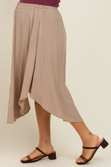 woman wearing a beige maternity skirt with an asymmetrical hem and a comfortable elastic waistband