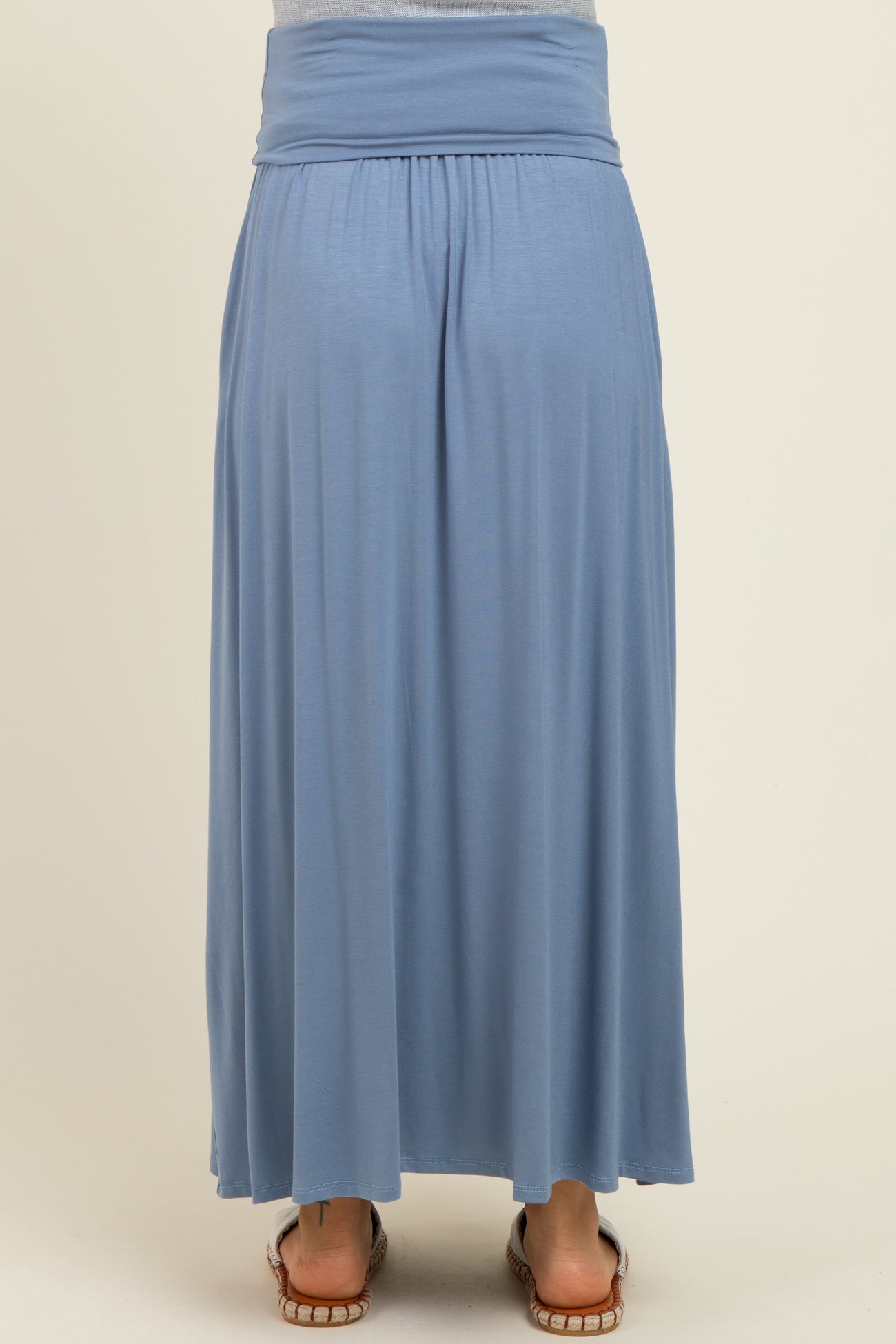 woman wearing a light blue maternity maxi skirt with a comfortable stretchy waistband, seen from the back