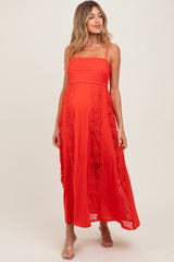 woman wearing a red maternity maxi dress with lace detailing, showcasing a baby bump