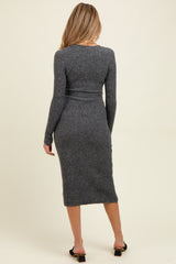 woman wearing a fitted dark grey ribbed maternity dress with long sleeves and a midi length