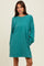woman wearing a teal oversized sweatshirt dress with long sleeves and side pockets