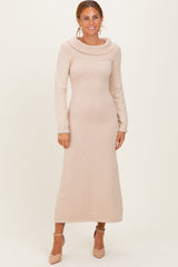 woman wearing a long sleeve light beige knit maxi dress with a decorative cowl neckline