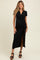 woman wearing a black maternity wrap dress with short sleeves and a side slit, showing her baby bump