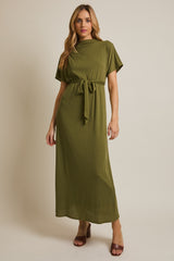 woman wearing an olive green short sleeve maxi dress with a belt and a ribbed texture