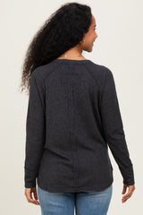 woman wearing a dark gray maternity long sleeve top, viewed from the back, with a relaxed fit and subtle seam details