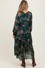 woman wearing a flowy green floral maternity maxi dress with long sleeves and ruffle details, showcasing a baby bump