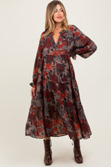 woman wearing a floral patterned maternity maxi dress with long sleeves and a tiered skirt