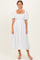 woman wearing a white floral midi dress with a square neckline and puff sleeves
