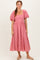 woman wearing a pink floral midi dress with puff sleeves and a square neckline