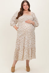 woman wearing a cream floral maternity maxi dress with puff sleeves and a baby bump