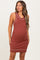 woman wearing a rust-colored maternity tank dress with ribbed texture and contrasting trim, showcasing her baby bump