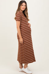 woman wearing a brown striped maternity dress and holding her baby bump
