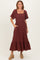 woman wearing a burgundy square neck maxi dress with short sleeves and a ruffled hem, featuring side pockets