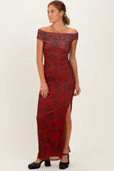 woman wearing a burgundy off-the-shoulder maxi dress with floral pattern and side slit