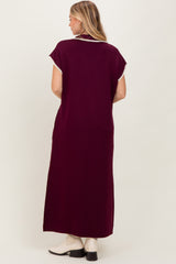 woman wearing a burgundy maxi dress with decorative trim on the neckline and short sleeves, shown from the back